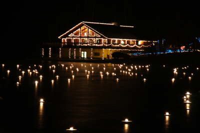 The Nature Center lit up with Christmas lights and lights in the pond